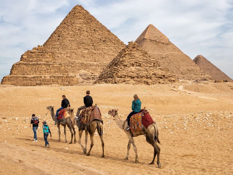A family camel caravan at the Giza Plateau